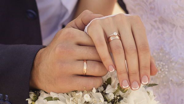 closeup-shot-of-newlyweds-holding-hands-and-showing-the-wedding-rings.jpg